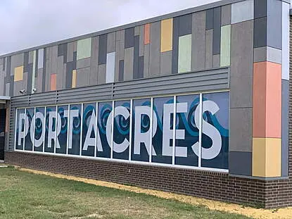 Modern building exterior with colorful panels and PORT ACRES signage